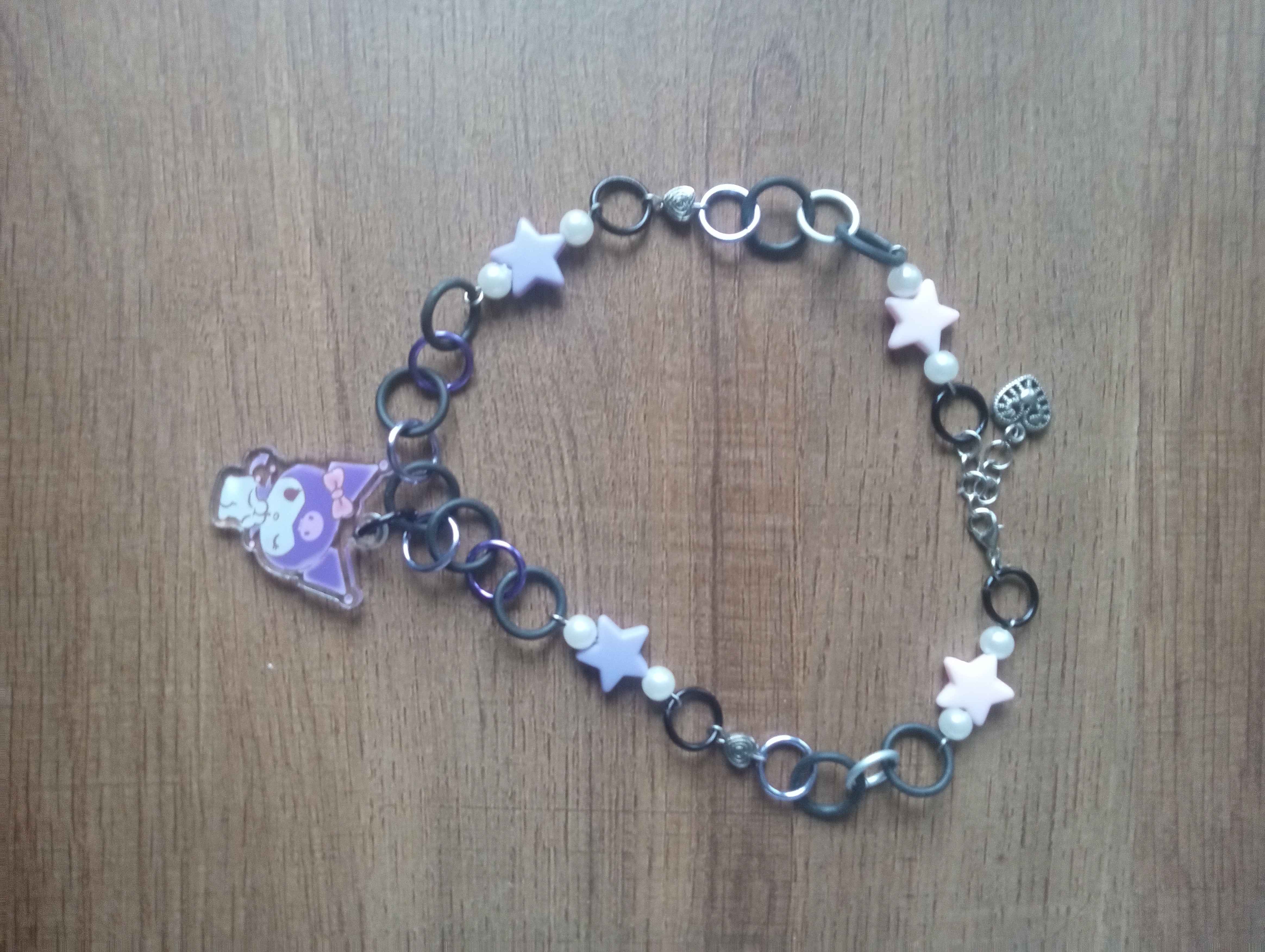 choker with a kuromi charm and purple and pink stars along the rest of it